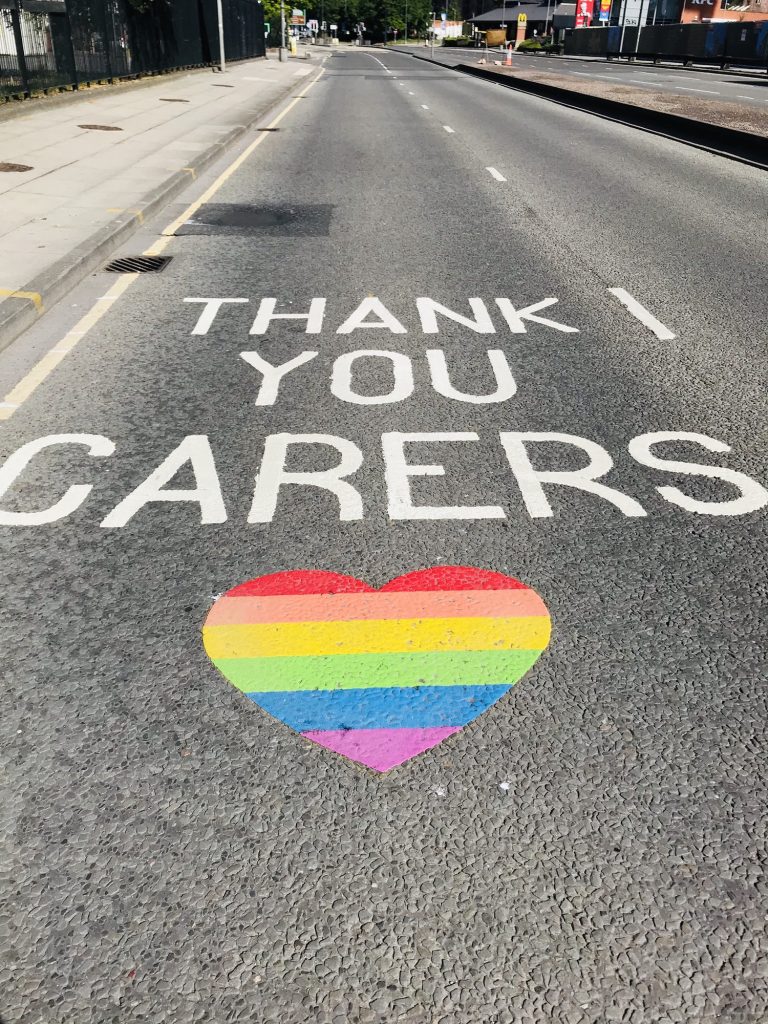 Coronavirus covid 19 pandemic quiet streets with rainbow sign thanking key workers for the nhs